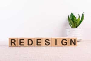 REDESIGN word made with building blocks on light background